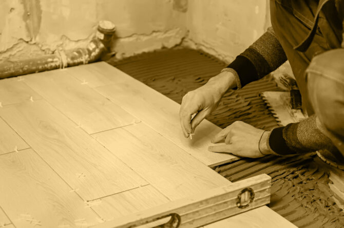 lay tiles on the floor in the house. Selective focus. white.