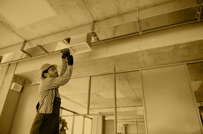 Ventilation cleaning. Specialist at work. Repair ventilation system (HVAC). Industrial background.